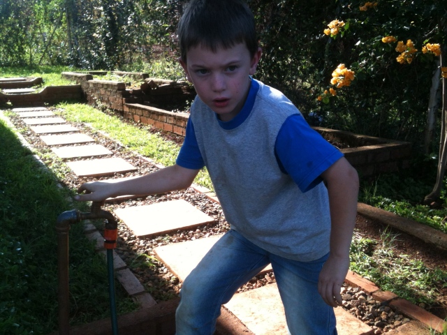Caleb was so intent on helping! I let him help with the cement layer after the tank was covered.