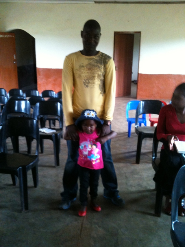 A young Christian father with his daughter and wife at church. 
