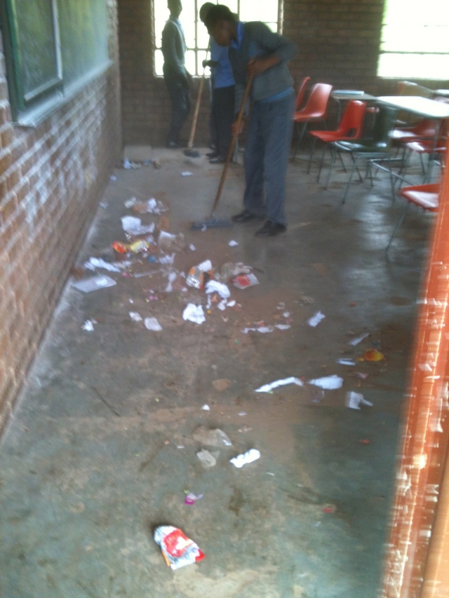 Seth instructed high school students to clean up their classroom before beginning an outreach economics course last week.