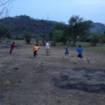 Americans with the Zim kids, playing "football."